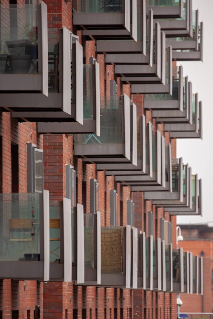 Close-up of contemporary apartment block with staggered glass balconies