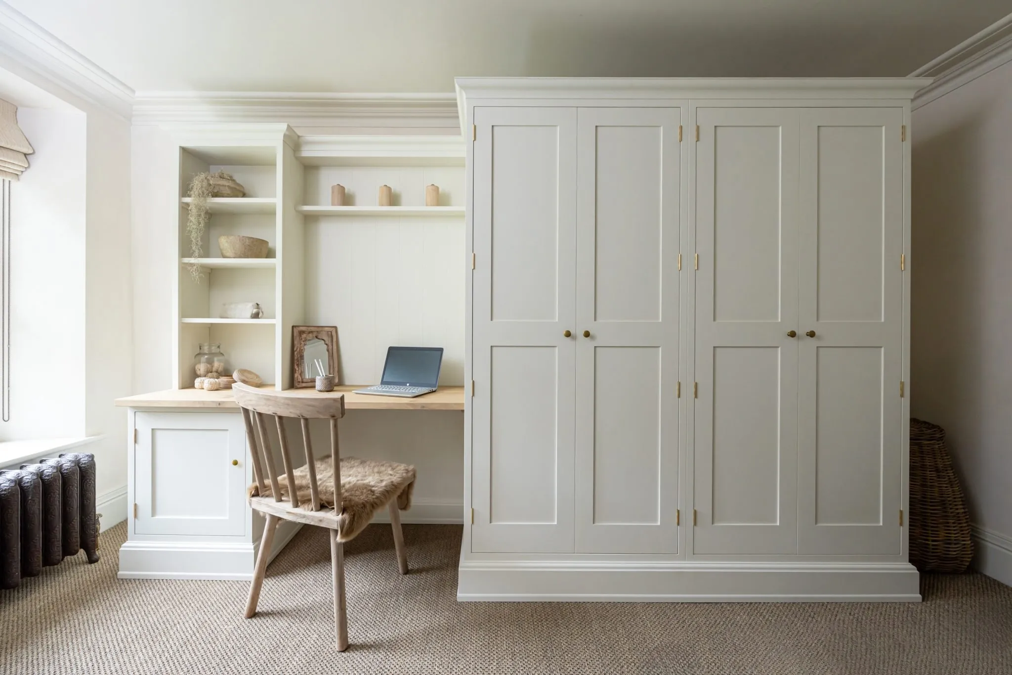 Built-in wardrobe and home office desk with wooden chair and soft natural tones