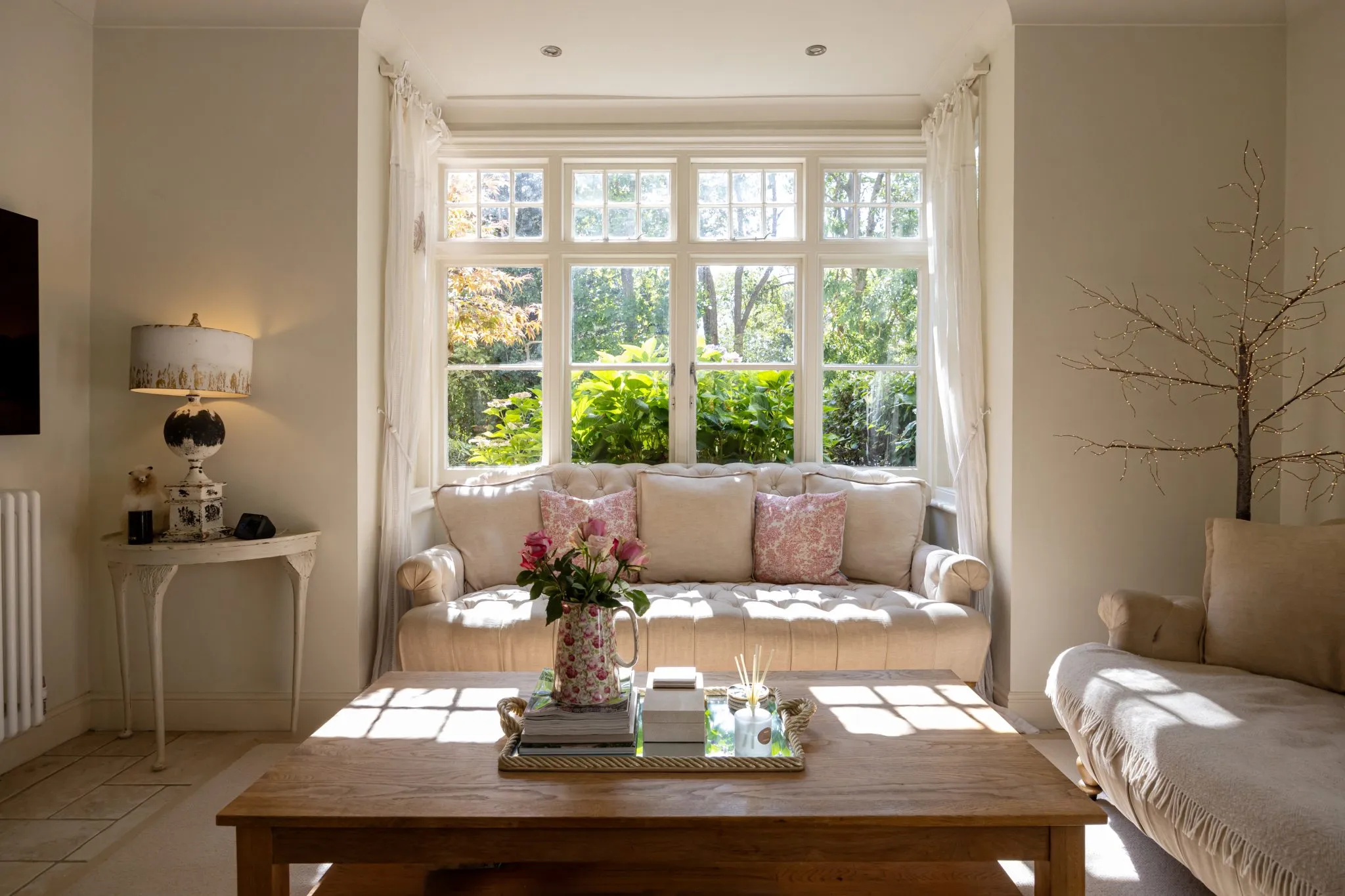 Living room with large window, white furniture and classic interior style – interior photography Manchester